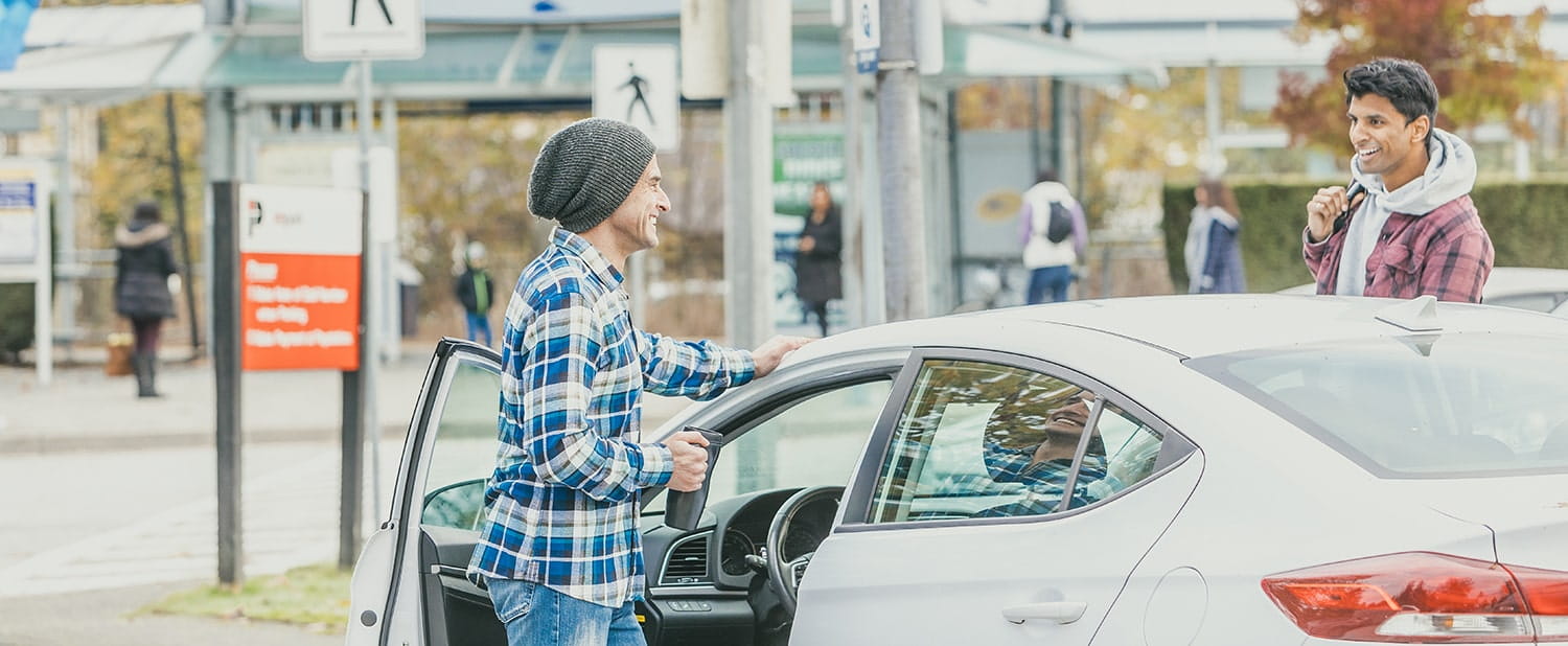 Two men getting out of a parked car