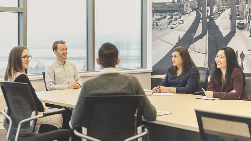 Two TransLink employees discussing a business case