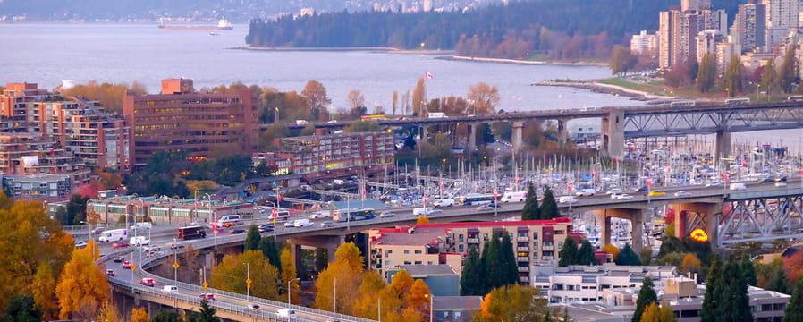 Cars driving across Granville Street bridge on a clear sunny day