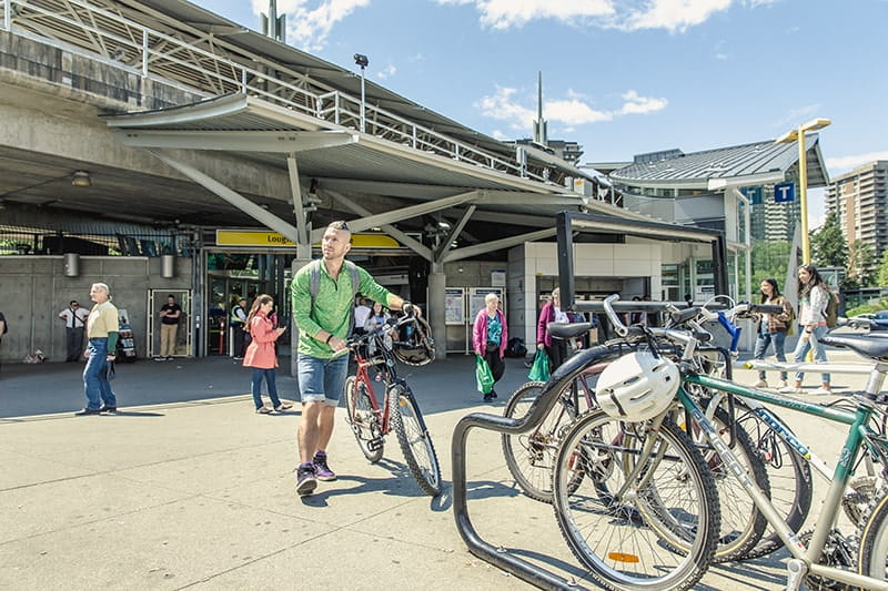 Woman carrying a bike in a SkyTrain station