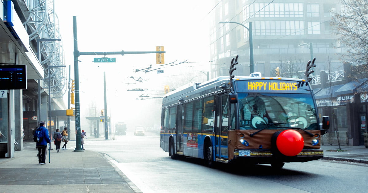 Reindeer Bus driving by Joyce—Collingwood Station and showing 